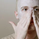 rapaz fazendo sua rotina de skincare diária.